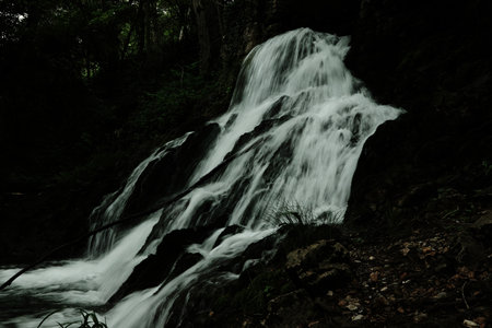 Close-up of a powerful waterfall in the forest, cascading down over mossy rocks near the Gradac...