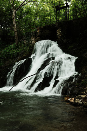 Close-up of a powerful waterfall in the forest, cascading down over mossy rocks near the Gradac...