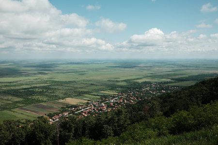 Wide panoramic view of Vrsac and surrounding Serbian countryside under a dramatic cloudy sky in springの写真素材