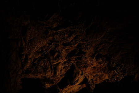 Stalactites and limestone textures illuminated in Lazarev cave, Serbia. Dramatic underground chamber...