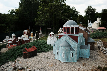 Colorful miniatures of churches with domes and traditional architecture displayed in an open-air...