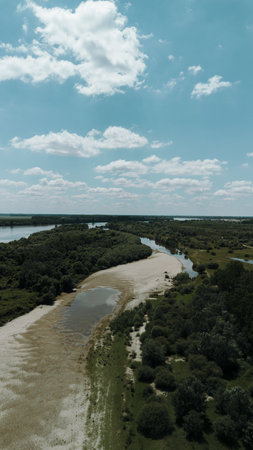 Aerial view of Danube River meandering through forested landscape and sandbanks near Belegis,...