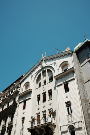 Elegant white Art Nouveau building in Belgrade with decorative facade and sculptural details, seen...