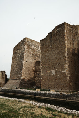 View of massive stone towers and ramparts of Smederevo Fortress, Serbia, with a moat in front. Historic medieval defensive structureの写真素材