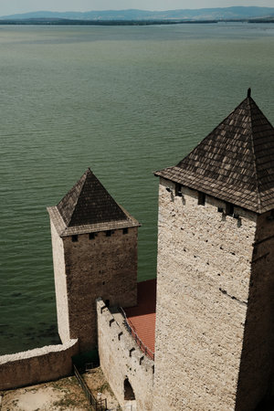 Stone towers with red roofs overlooking the Danube River at Golubac Fortress in Serbia country. View...