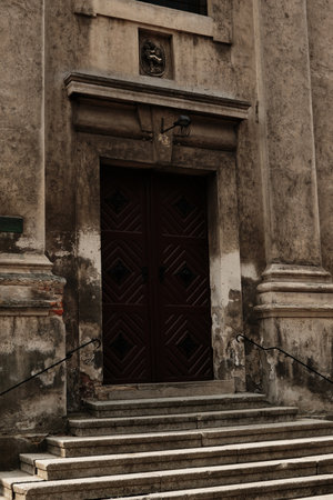 Close-up view of the worn entrance and stairs of a historic church in Novi Sad, Serbiaの写真素材