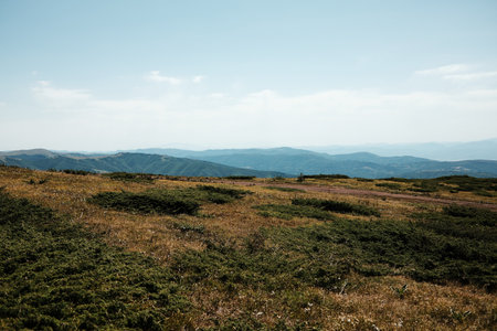 Expansive mountain view from Stara Planina, Serbia, with rolling hills and grassy plateaus stretching into the horizonの写真素材
