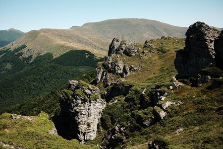 Rocky cliffs and green slopes of Stara Planina with mountain ridges in the distance. Babin Zub mount in summer season. Serbia countryの写真素材