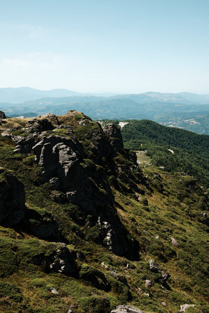 Rocky cliffs and green slopes of Stara Planina with mountain ridges in the distance. Babin Zub mount in summer season. Serbia countryの写真素材