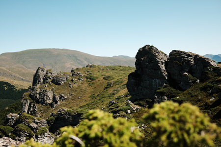 Scenic rocky cliffs with green vegetation and distant hills in Stara Planina. Babin Zub mount in summer season. Serbia country.の写真素材