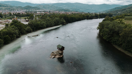 Aerial view of the famous Drina River House in Serbia, standing alone on a rock in the middle of...