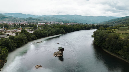 Aerial view of the famous Drina River House in Serbia, standing alone on a rock in the middle of...