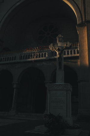 Statue of Christ crucifixion in front of church entrance in Subotica during wintertimeの写真素材