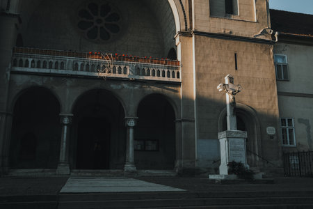 Statue of Christ crucifixion in front of church entrance in Subotica during wintertimeの写真素材
