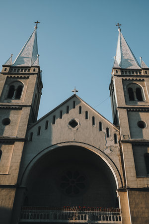 Low angle view of twin church towers in Subotica, Serbia, under clear blue sky in winterの写真素材