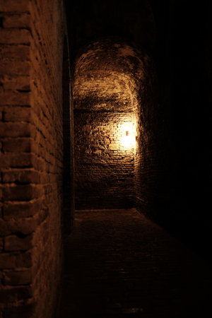Brick tunnel with arched ceiling and glowing lamp inside Kalemegdan underground, Belgradeの写真素材