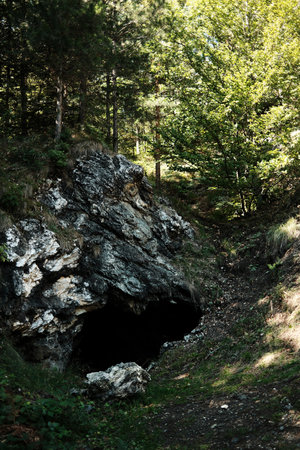 Rock cave entrance surrounded by forest in Divcibare, Serbia. Natural landscape with rocky formationの写真素材