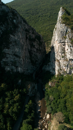 Drone view of the river cutting through dramatic cliffs of Jerma Canyon, Serbia. Aerial vertical...
