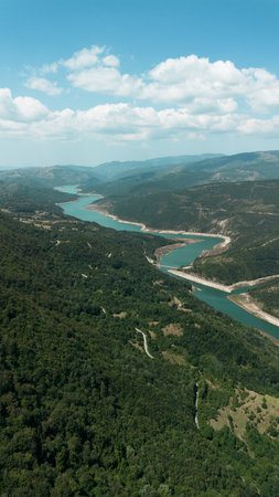 Aerial view of Zavoj Lake in Stara Planina National Park, Serbia, surrounded by green mountains and forested hillsの写真素材