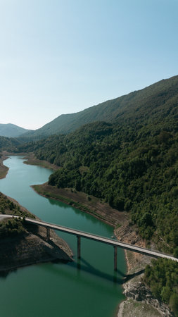 Scenic aerial view of Zavoj Lake with a bridge crossing between green forested mountains in Serbia Stara Planina National Parkの写真素材