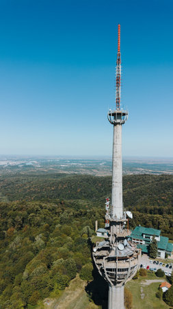 Aerial view of TV tower Iriski Venac rising above the forested hills of Fruska Gora National Park with panoramic landscapes.の写真素材