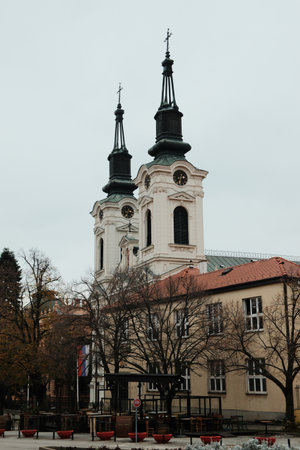 View of twin towers and rooftops in Sremski Karlovci, Serbia. A concept of heritage, winter mood, and cultural identityの写真素材