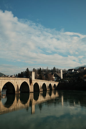 Historic Mehmed Pasha Sokolovic Bridge spans the Drina River in Visegrad, Bosnia and Herzegovina. Stone arches and soft reflections highlight the calm atmosphere of this iconic landmarkの写真素材