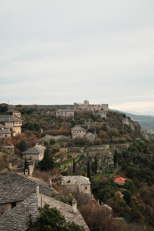 Wide view of Pocitelj Fortress with stone houses and terraced gardens on the hillside above the Neretva River, showing preserved medieval village architecture in Bosnia and Herzegovinaの写真素材