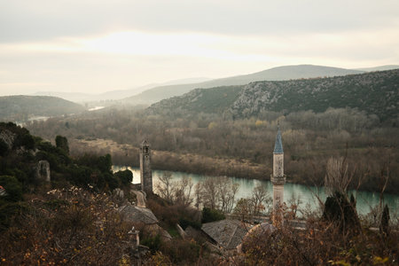 Panoramic view of Pocitelj village and fortress overlooking the Neretva River in Bosnia and Herzegovina. Stone houses and hills form a timeless cultural travel conceptの写真素材