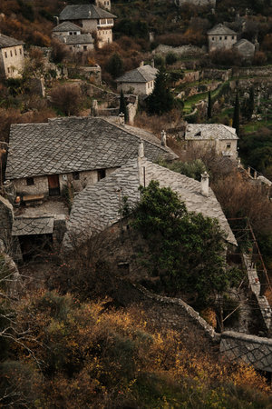 Traditional stone rooftops and narrow paths inside Pocitelj Fortress village, showing preserved medieval residential architecture on a hillside in Bosnia and Herzegovinaの写真素材