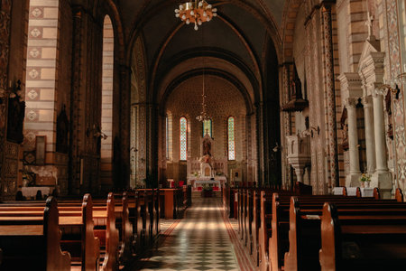 Ornate interior of the Catholic cathedral in Subotica with wooden pews and altar view. Subotica, Serbia - April 27, 2026