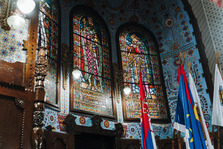 Subotica, Serbia - July 16, 2026. Historic stained glass windows and ceremonial flags inside the Art Nouveau council chamber of Subotica City Hall