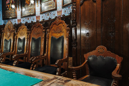Subotica, Serbia - July 16, 2026. Historic carved wooden chairs inside the Art Nouveau council chamber of Subotica City Hall