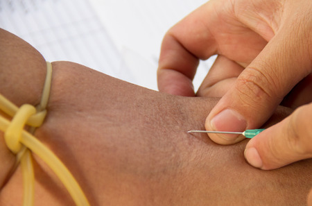 Nurse collecting a blood from a patient