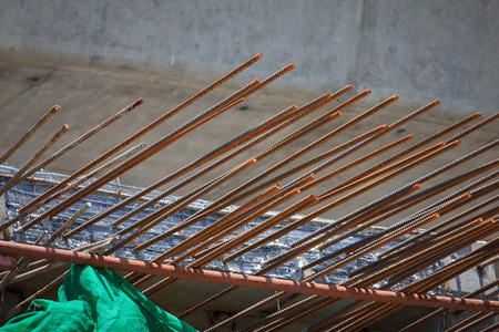 concrete piles in a construction area with rusty rebar