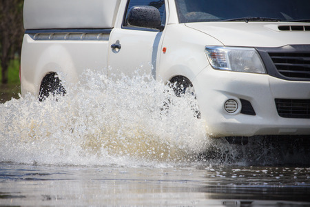 Splash by a car as it goes through flood water