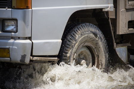 Splash by a truck as it goes through flood waterの写真素材