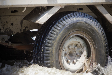 Splash by a truck as it goes through flood water