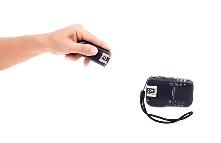 Wireless Flash Trigger in hand, Isolate on white backgroundの写真素材