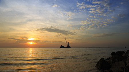 Clouds spread across the sky before sunset at Bangpu seaside, gulf of thailand with Cargo ships sail past at evening times.の写真素材