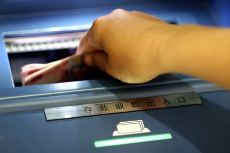 Take cash from the ATMの写真素材