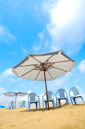 Chairs and umbrella on the beachの写真素材