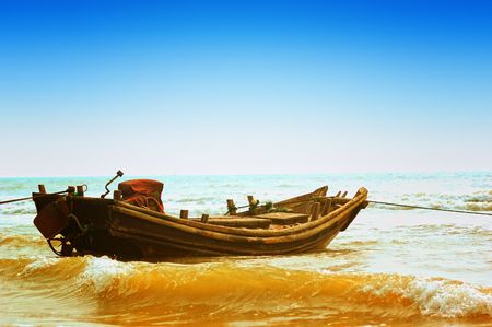Boat alone on seashoreの写真素材