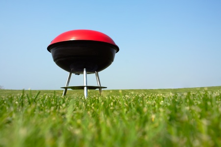 Barbeque grill on green meadowの写真素材