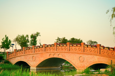Sunset landscape with brick arch bridge on the river,Chinaの写真素材