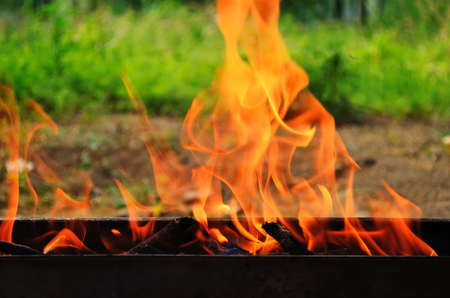 Fire on barbecue grill outdoorの写真素材