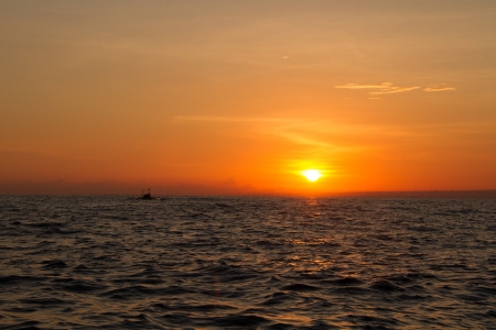 sunrise at lovina beach bali indonesiaの写真素材