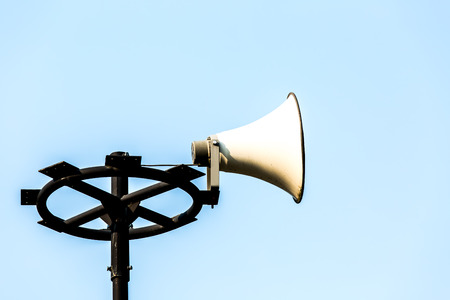 white loudspeaker on post