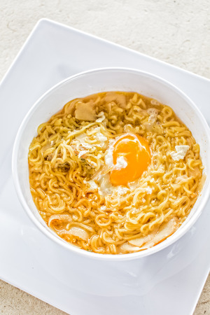 noodle with egg and fish on white plateの写真素材