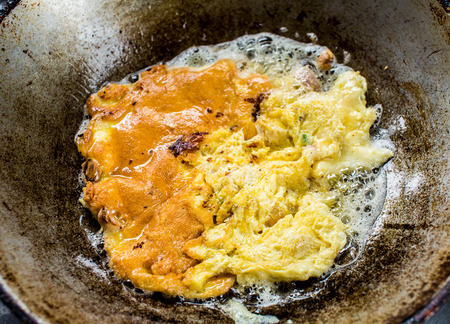 frying omlet in pan.の写真素材